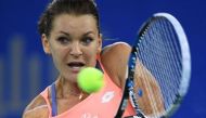Agnieszka Radwanska of Poland hits a return during her quarter-final match against Svetlana Kuznetsova of Russia at the WTA Wuhan Open tennis tournament in Wuhan, in China's central Hubei province on September 29, 2016. / AFP / GREG BAKER