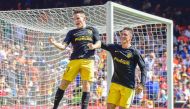 Atletico Madrid's French forward Kevin Gameiro (L) celebrates a goal with Atletico Madrid's forward Fernando Torres during the Spanish league football match Valencia FC vs Club Atletico de Madrid at Mestalla stadium in Valencia on October 2, 2016. / AFP /