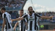 Juventus' forward from Argentina Gonzalo Higuain celebrates with teammates after scoring during the Italian Serie A football match Empoli vs Juventus, on October 2, 2016 at Empoli's 