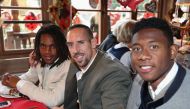 (R-L) David Bayern Munich's Austrian defender David Alaba, French midfielder Franck Ribery and Portuguese midfielder Renato Sanches pose during the traditional visit of FC Bayern Munich at the Oktoberfest beer festival in Munich, southern Germany, on Octo