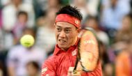 Kei Nishikori of Japan returns a shot against Joao Sousa of Portugal during the men's singles second round match at the ATP Japan Open tennis tournament in Tokyo on October 5, 2016. / AFP / TORU YAMANAKA