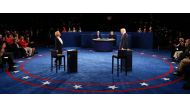 TOPSHOT - Democratic nominee Hillary Clinton (L) and Republican nominee Donald Trump arrive on stage during the second presidential debate at Washington University in St. Louis, Missouri on October 9, 2016. / AFP / POOL / JIM BOURG