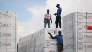 Workers load relief aid sent by the US onto a truck after Hurricane Matthew passed, in Port-au-Prince, Haiti, October 12, 2016. REUTERS/Jeanty Junior Augustin 