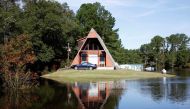 A home and vehicle share a temporary island as flood waters from the swollen Tar River inundate communities along its course in the aftermath of Hurricane Matthew, in Old Sparta, North Carolina, U.S. October 14, 2016. REUTERS/Jonathan Drake
