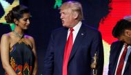Republican presidential nominee Donald Trump (C) gets help lighting a ceremonial diya lamp before he speaks at a Bollywood-themed charity concert put on by the Republican Hindu Coalition in Edison, New Jersey, U.S. October 15, 2016. Reuters/Jonathan Ernst