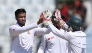 Bangladesh' Shakib Al Hasan (L) with captain Mushfiqur Rahim celebrates the wicket of England's Ben Duckett during the third day of the first Test match between Bangladesh and England at Zahur Ahmed Chowdhury Cricket Stadium in Chittagong on October 22, 2