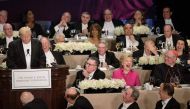 Democratic presidential nominee Hillary Clinton laughs at as Republican presidential nominee Donald Trump tells a joke during the Alfred E. Smith Memorial Foundation Dinner at Waldorf Astoria October 20, 2016 in New York. AFP / Brendan Smialowski