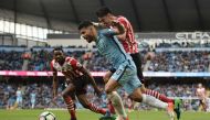 Manchester City's Argentinian striker Sergio Aguero vies with Southampton's Portuguese defender Jose Fonte (R) during the English Premier League football match between Manchester City and Southampton at the Etihad Stadium in Manchester, north west England