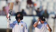 Bangladesh Sabbir Rahman celebrates a half-century (50 runs) as England's captain Alastair Cook looks on during the fourth day's play of the first Test cricket match between Bangladesh and England at Zahur Ahmed Chowdhury Cricket Stadium in Chittagong on 
