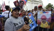 Supporters of Venezuelan President Nicolas Maduro, demonstrate outside the National Assembly during an extraoridinary session called by opposition leaders, in Caracas on October 23, 2016. The Democratic Unity Movement(MUD), opposite to Nicolas Maduro's go