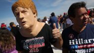 People wait for the arrival of Republican presidential candidate Donald Trump for his campaign rally at the Million Air Orlando, which is at Orlando Sanford International Airport on October 25, 2016 in Sanford, Florida. Trump continues to campaign against