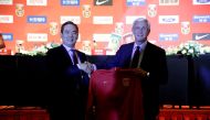 Marcello Lippi (R) and Cai Zhenhua, president of the Chinese Football Association (CFA), shake hands as Marcello Lippi is given China's national team coach shirt at a news conference in Beijing, China October 28, 2016. REUTERS/Jason Lee
