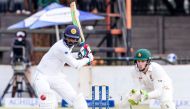 Sri Lanka batsman Upul Tharanga is in action as Peter Moor looks on during the second day's play in the first Test match between Sri Lanka and hosts Zimbabwe at the Harare Sports Club, on October 30, 2016. (AFP / Jekesai Njikizana)