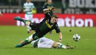 Andre Hahn (L) of Moenchengladbach challenges Stuart Armstrong of Celtic Glasgow during the UEFA Champions League group C soccer match between Borussia Moenchengladbach and Celtic Glasgow at the Borussia Park stadium in Moenchengladbach, Germany on Novemb