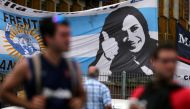 Supporters of former Argentine President Cristina Fernandez de Kirchner stand in front of a banner with her image as they wait for her to leave court in Buenos Aires, Argentina, October31, 2016. REUTERS/Marcos Brindicci
