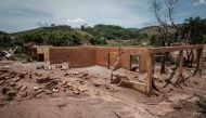 Picture taken on October 27, 2016, showing remains of houses damaged by the flood following the deadly collapse of the Samarco iron-ore mine dam last year, at the village of Paracatu de Baixo in Mariana of Minas Gerais State, Brazil. AFP / YASUYOSHI CHIBA