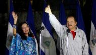 Daniel Ortega, Nicaragua's current president and presidential candidate from the ruling Sandinista National Liberation Front, shows his ink stained thumb to the media beside his wife Rosario Murillo after they casting their vote at a polling station durin