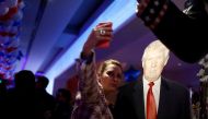 A woman photographs herself with a cardboard figure of U.S. Republican presidential candidate Donald Trump in Berlin, Germany, November 8, 2016. REUTERS/Axel Schmidt