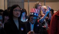 People get news on their smartphones as they follow the results of the final day of the US presidential election at an event organised by the US consulate in Shanghai on November 9, 2016. Donald Trump's stunning performance in the US presidential election