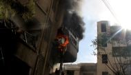 Flame and smoke rises from a building after the war crafts belonging to the Russian Army and Syrian regime carried an airstrike over residential areas in Duma district of Damascus on November 7, 2016. ( Amaar Doumani - Anadolu Agency )
