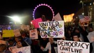 Anti-Donald Trump protesters hold signs as they gather at The Linq Promenade before marching on the Las Vegas Strip on November 12, 2016 in Las Vegas, Nevada. The election of Trump as president has sparked protests in cities across the country. (Ethan Mil