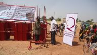 A farmer receiving agricultural equipment under an empowerment scheme run by Qatar Charity in Burkina Faso.