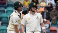 This file photo taken on November 15, 2016 shows Australia's batsman Adam Voges (L) waiting for the third umpire's decision with team captain Steven Smith on the fourth day of play in the second Test cricket match between Australia and South Africa in Hob