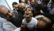 A relative of Palestinian Mohammed Abu Saada, who was killed on Friday during clashes with the Israeli troops near the Gaza-Israel border, mourns at a hospital morgue in the central Gaza Strip November 18, 2016. REUTERS/Ibraheem Abu Mustafa