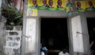 A tailor works in a workshop with posters of presidential candidate Jude Celestin of LAPEH (Alternative League for Progress and Emancipation of Haiti) on the facade, before the election in a street of Les Cayes, Haiti, November 19, 2016. REUTERS/Andres Ma