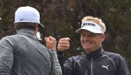 Thorbjorn Olesen (L) and teammate Soren Kjeldsen of Denmark bump fists during the third day of the World Cup of Golf on the Kingston Heath course in Melbourne on November 26, 2016. AFP / PAUL CROCK 
