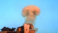Smoke rises from a damaged building after a strike on the rebel-held besieged Al Shaar neighbourhood of Aleppo, Syria, yesterday.