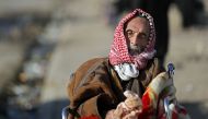 A displaced Iraqi man, who fled his home, waits to be transferred to a camp, on November 28, 2016 in the village of Gogjali, on the eastern edge of Mosul, during the ongoing figthing between Islamic State (IS) group jihadists and government forces. Some 7