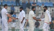 Indian batsman and captain Virat Kohli (L) shakes hands with England bowler Moen Ali after winning the third Test cricket match between India and England at The Punjab Cricket Association Stadium in Mohali on November 29, 2016. (AFP / Sajjad Hussain)