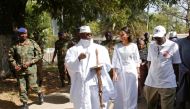 Gambian President Yahya Jammeh leaves a polling station with his wife Zineb during the presidential election in Banjul, Gambia, December 1, 2016. (Reuters/Thierry Gouegnon)