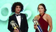 Emirate's Omar Abdulrahman (left), carrying the AFC Men's Footballer of the Year trophy, and  Australia's Caitlin Foord, carrying the AFC Women's Footballer of the Year, pose for a picture during the Asian Football Confederation's Annual Awards ceremony i