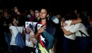 University students react while watching the television transmission of the event being held in Santiago de Cuba in honor of former President Fidel Castro, in Havana, Cuba, December 3, 2016. REUTERS/Stringer EDITORIAL USE ONLY. NO RESALES. NO ARCHIVE