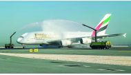 The Emirates A380 is greeted by a water cannon salute at Hamad International Airport in Doha.