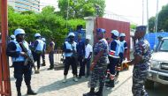 Anti-riot policemen led by Divisional Superintendent of Police Kumashie Freeman (centre) stand at the main gate that leads to the headquarters of the Electoral Commission, in Accra, yesterday.