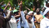 Supporters of the National Democratic Party (NDC) dance and cheer as they wait the results of the general elections, outside incumbent President John Mahama's house, in Labone, yesterday.