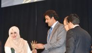  Emir presenting an award to Hanan Khandakji, a Palestinian journalist, for her contributions to investigative journalism.