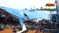 People stand near the remains of a church which collapsed during a service in the southern city of Uyo in Akwa Ibom state, Nigeria in this still image from video December 10, 2016. Video taken December 10, 2016. 