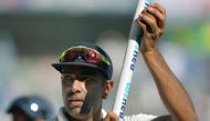 India's Ravichandran Ashwin celebrates during a victory lap after winning the fourth Test cricket match against England at the Wankhede stadium in Mumbai on December 12, 2016. GETTYOUT / AFP / PUNlT PARANJPE