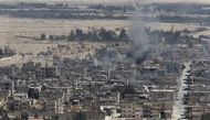 FILE PHOTO Smoke rises from the modern city of Palmyra, in Homs Governorate, Syria April 1, 2016. REUTERS/Omar Sanadiki/File Photo
