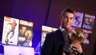 Handout photo released on December 12, 2016 by L'Equipe shows Portugese player Cristiano Ronaldo posing with the Ballon d'Or France Football trophy in Madrid. AFP PHOTO / FRANCK SEGUIN /  L'Equipe