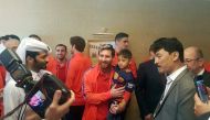 A handout picture released by Qatar?s Supreme Committee for Delivery and Legacy on December 13, 2016 shows Barcelona's Argentinian forward Lionel Messi (C-L) holding six-year-old Afghan boy Murtaza Ahmadi (C-R) in Doha