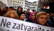 Bosnian people hold up placards during a protest in Sarajevo, Bosnia and Herzegovina, to show solidarity with trapped citizens of Aleppo in Syria, December 14, 2016. REUTERS/Dado Ruvic