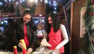 Syrian refugees Mayar and Nawar Ballish serve falafel sandwiches at a traditional German Christmas market in the small Bavarian town of Schillingsfuerst, Germany November 11, 2016. REUTERS/Michelle Martin