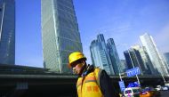 A worker walks outside a construction site in Beijing.