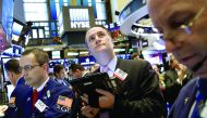 Traders work on the floor of the New York Stock Exchange (NYSE) yesterday.