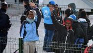 FILE PHOTO: Unaccompanied migrant minors from the demolished migrant camp in Calais wait to board a bus to be transferred to reception centres around France on November 2, 2016 in Calais, northern France (AFP) 